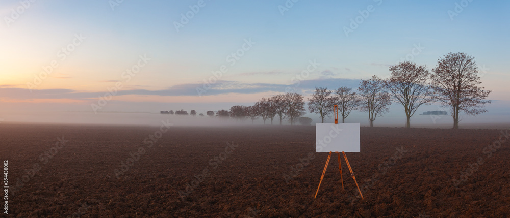 Blank art board and realistic wooden easel on the field. Blank art board and realistic wooden easel on the field.