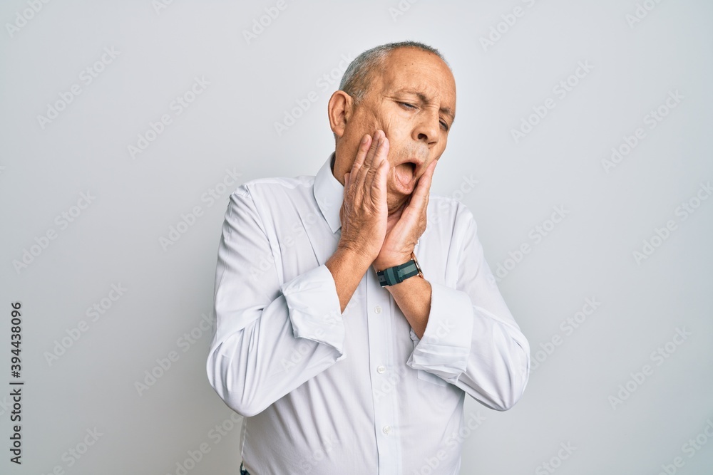 Handsome senior man wearing casual white shirt tired hands covering face, depression and sadness, upset and irritated for problem Handsome senior man wearing casual white shirt tired hands covering face, depression and sadness, upset and irritated for problem