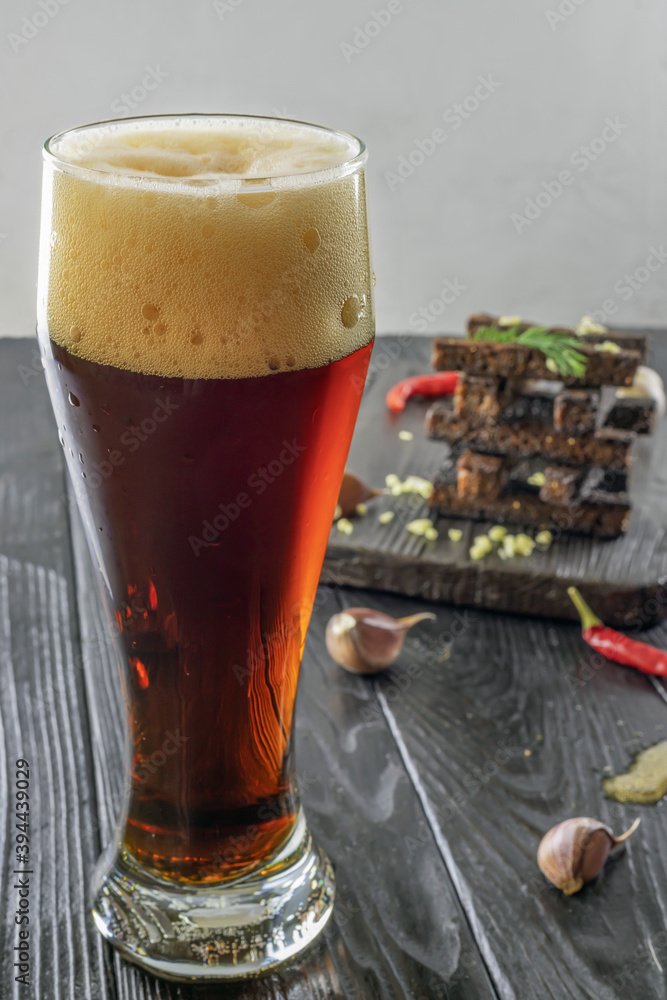 glass of dark beer with crunchy rye croutons glass of dark beer with crunchy rye croutons