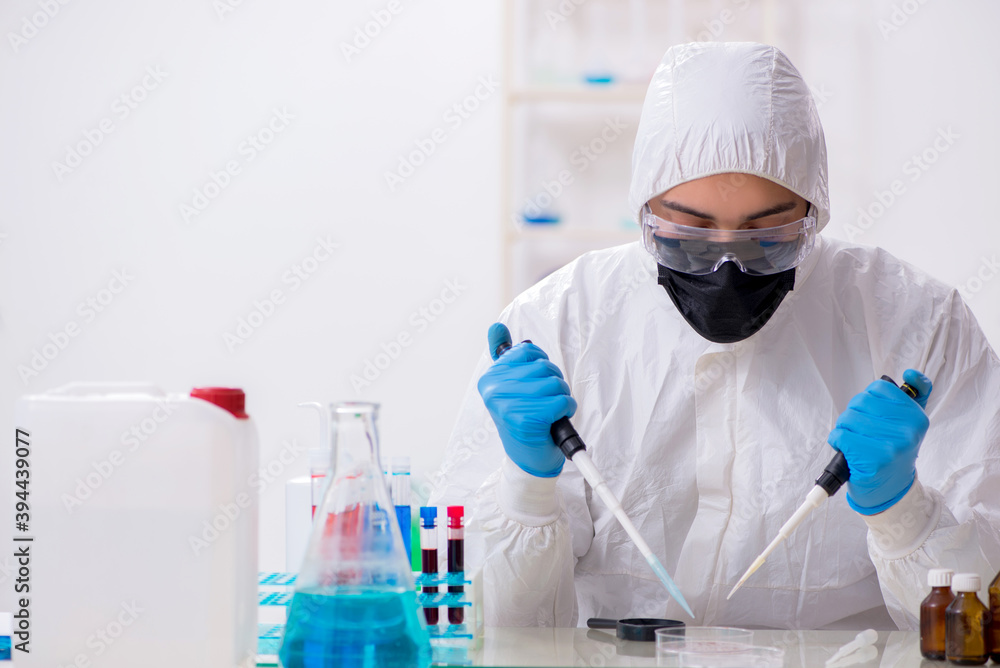 Young male chemist working in medicine lab Young male chemist working in medicine lab
