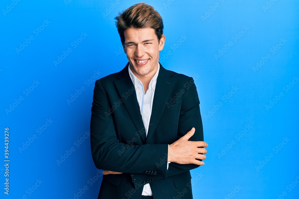 Handsome caucasian man wearing business suit and tie happy face smiling with crossed arms looking at the camera. positive person. Handsome caucasian man wearing business suit and tie happy face smiling with crossed arms looking at the camera. positive person.