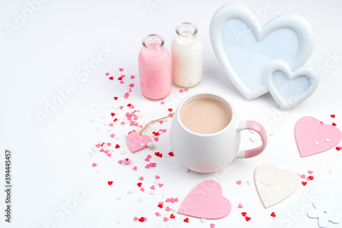 Delicate romantic composition for February 14 with a Cup of coffee  frame  hearts in white and pink flowers. The view from the top. Concept of holiday backgrounds.