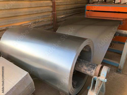 Rolled halvanized metal at construction site workshop. Tinsmith metal material