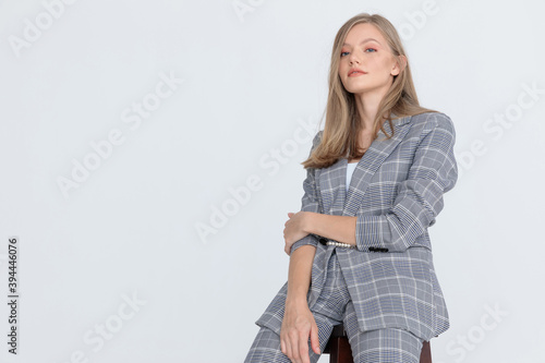smiling young lady holding arms in a fashion pose