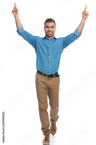 attractive casual man pointing at the sky