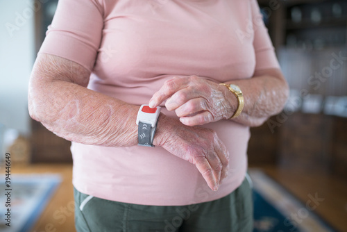 Senior woman using alert bracelet, Sweden