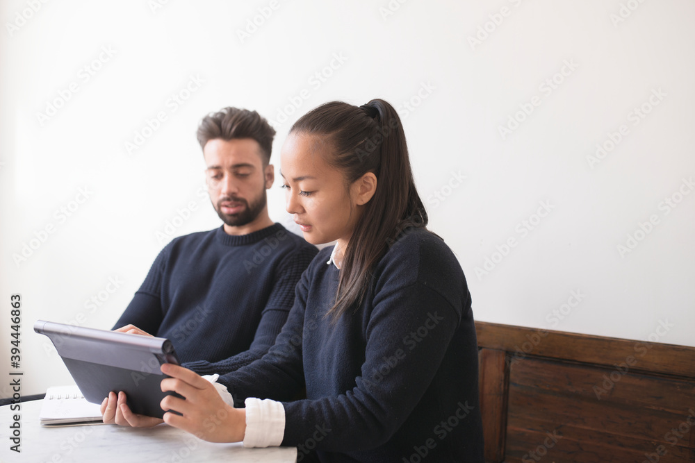 Couple in cafe using digital tablet, Sweden Couple in cafe using digital tablet, Sweden