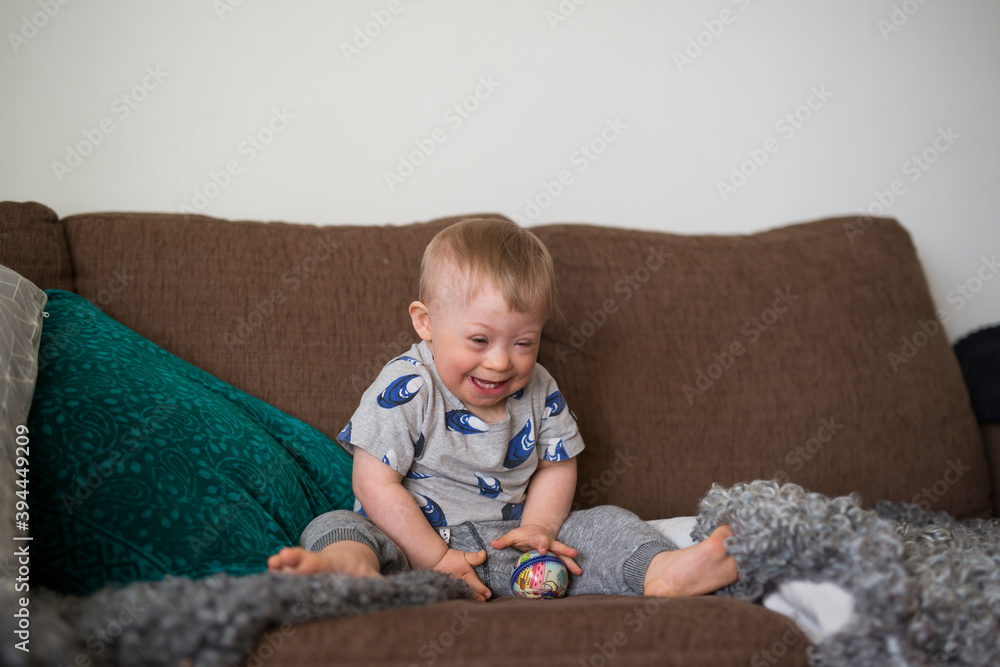 Laughing boy on sofa, Sweden Laughing boy on sofa, Sweden