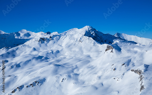 Drone image of mountains in winter. Image with snow  texture and shadows. 