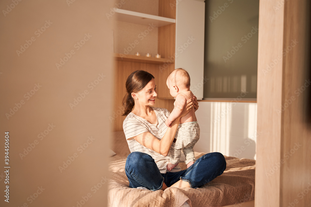 Woman playing with her newborn son Woman playing with her newborn son