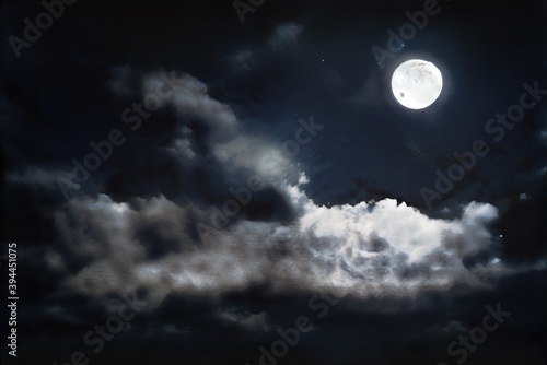 Moon in cloudy, stormy sky at night