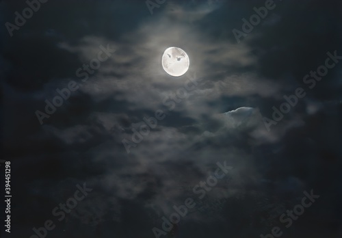 Moon in cloudy, stormy sky at night