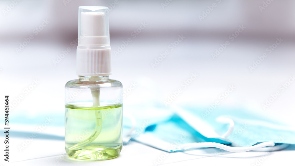 Close up image of small bottle antiseptic hand sanitizer hygiene spread protection with blue face travel surgical disposable mask on the desk, coronavirus prevention disease flu cold weather.
Close up image of small bottle antiseptic hand sanitizer hygiene spread protection with blue face travel surgical disposable mask on the desk, coronavirus prevention disease flu cold weather.