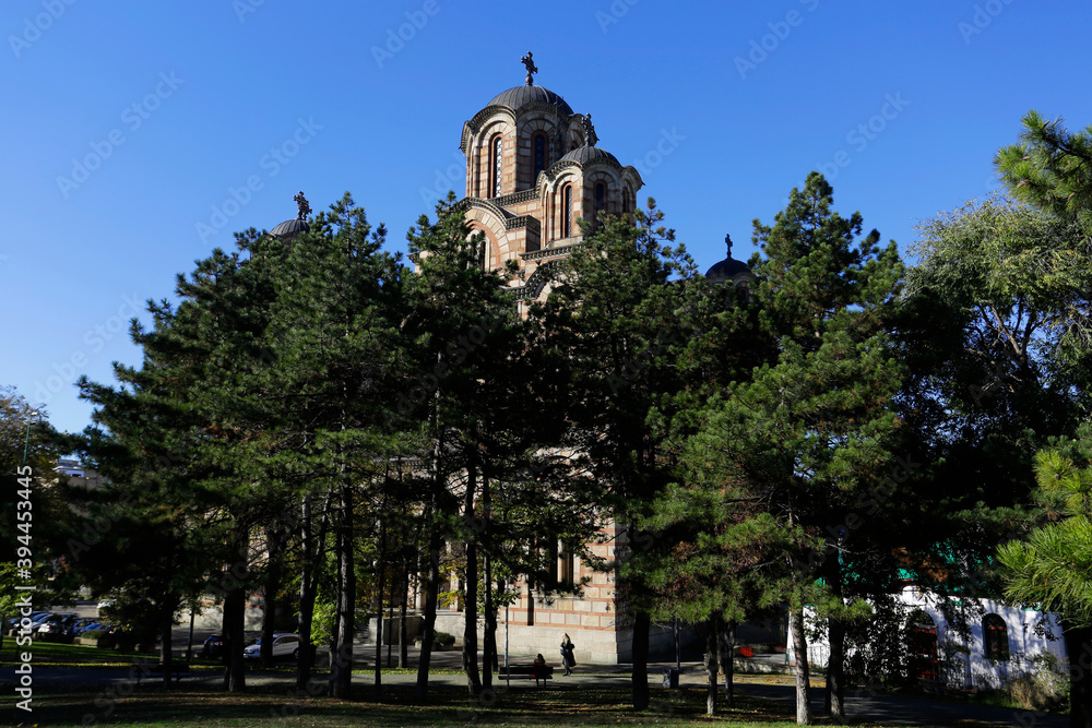 View of St. Mark's orthodox church amid trees in Tasmajdan park, during a sunny autumn day in Belgrade, Serbia.