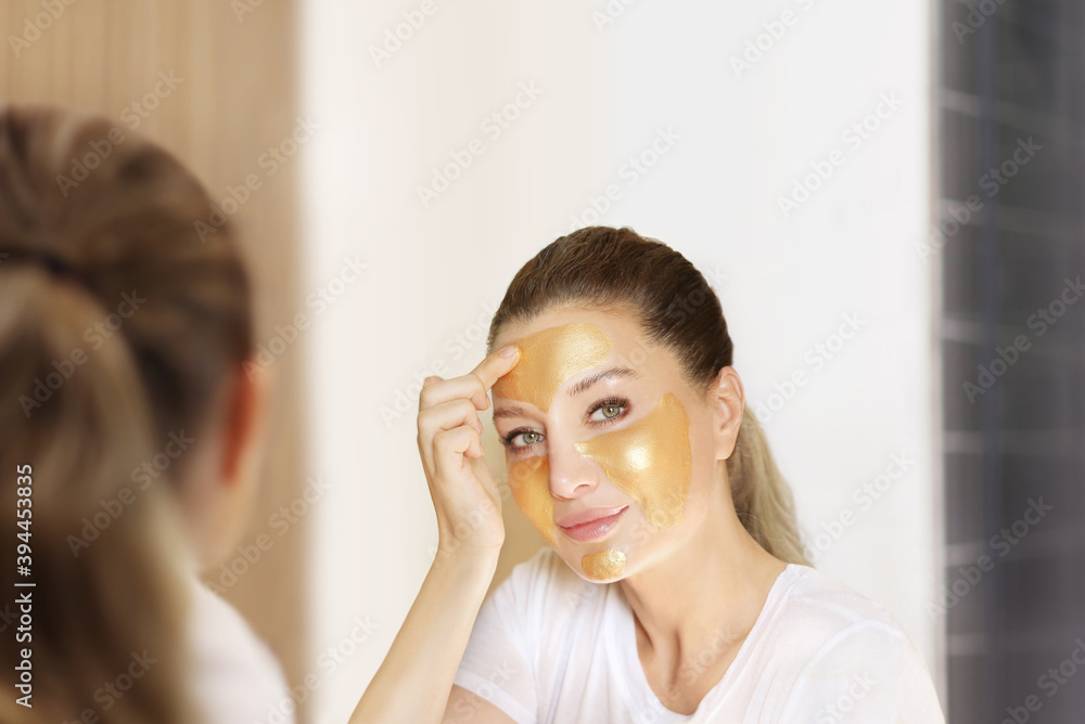 Anti-aging therapy. young woman applying facial mask. woman moisturizing face mask. Cosmetology and skin care concept.. Anti-aging therapy. young woman applying facial mask. woman moisturizing face mask. Cosmetology and skin care concept..