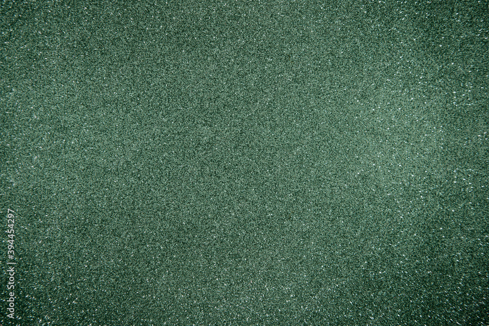 Fototapeta premium Glitter green background. Photo of monotone shiny background.