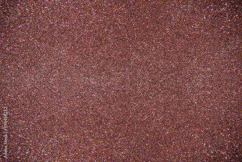 Glitter brown background. Photo of monotone shiny background.