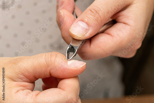 nail cuticle removal with nippers before manicure photo