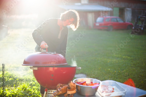 Woman having grill in garden, Sweden photo