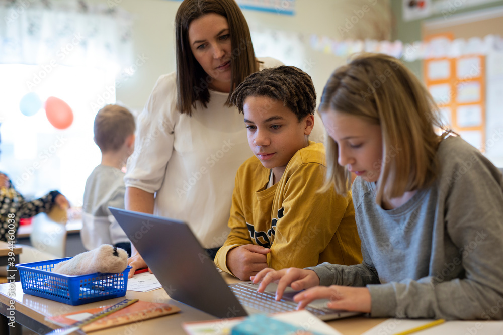 Teacher with children in classroom, Sweden Teacher with children in classroom, Sweden