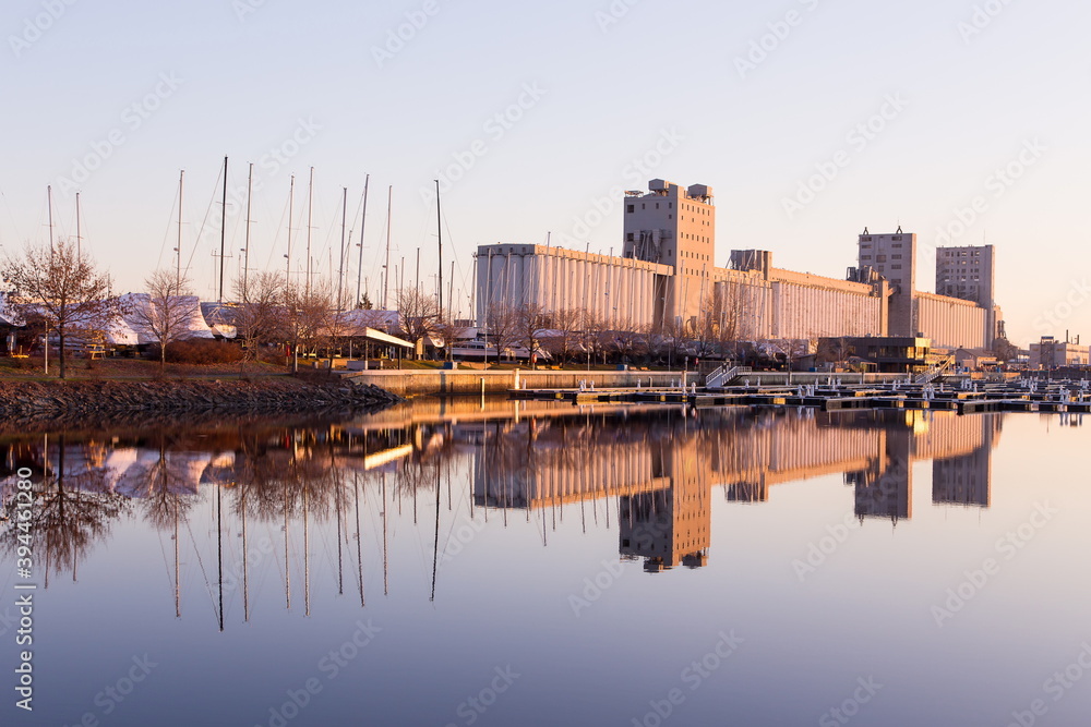 South view of industrial buildings and docked sailboats seen around the Louise Basin during a sunny late Fall early morning, Quebec City, Quebec, Canada