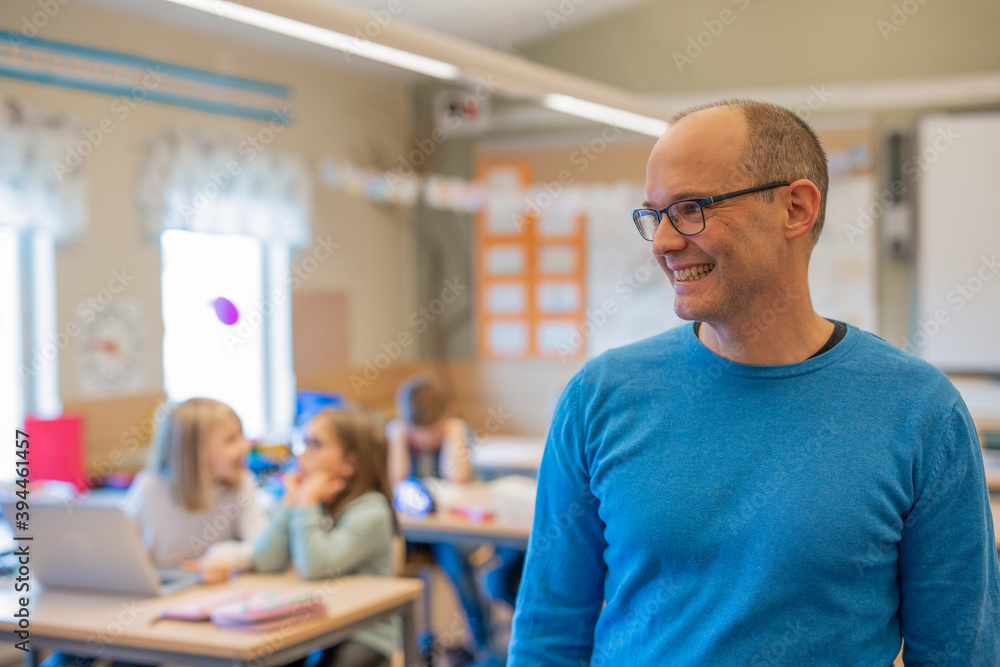 Smiling teacher in classroom, Sweden Smiling teacher in classroom, Sweden