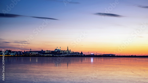 View of the Kazan Kremlin from the ice of the river at sunset. © delobol