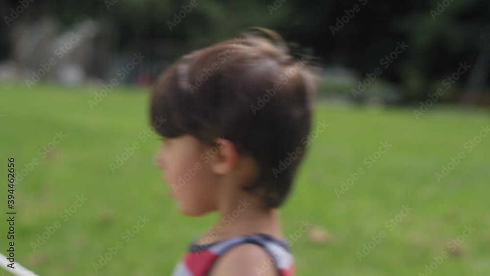 Close-up of a young boy blowing bubbles in a park on a summer day Close-up of a young boy blowing bubbles in a park on a summer day