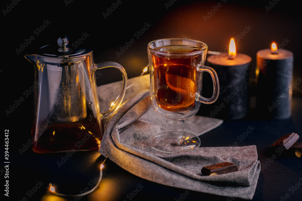 Transparent glass teapots with tea on the glass Transparent glass teapots with tea on the glass