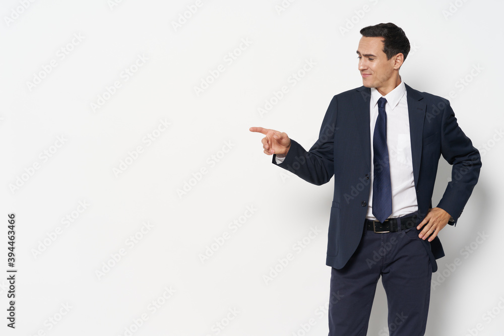 Business man in a suit tie self-confidence shows a finger to the side Business man in a suit tie self-confidence shows a finger to the side