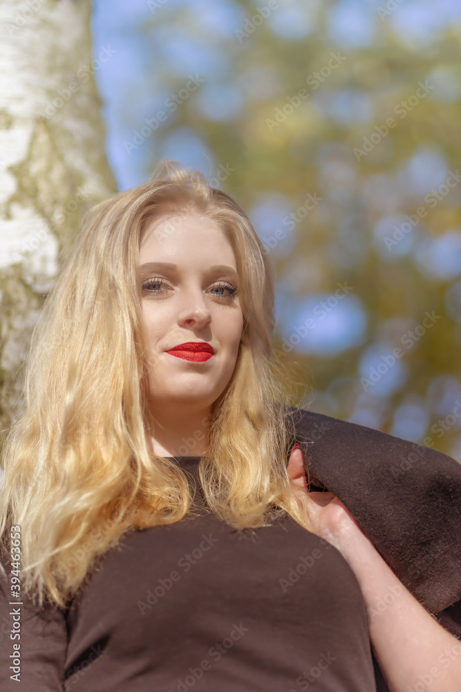 Portrait of attractive girl smiling at the camera. Photo in soft light autumn colors. Vertically. Portrait of attractive girl smiling at the camera. Photo in soft light autumn colors. Vertically.