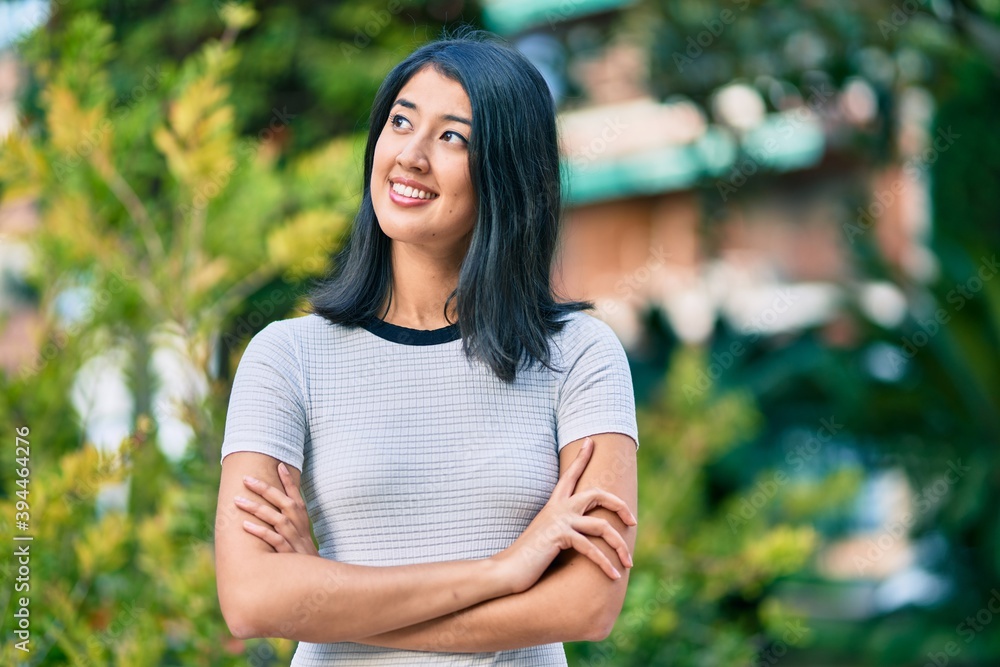 Young hispanic woman with crossed arms smiling happy at the park. Young hispanic woman with crossed arms smiling happy at the park.