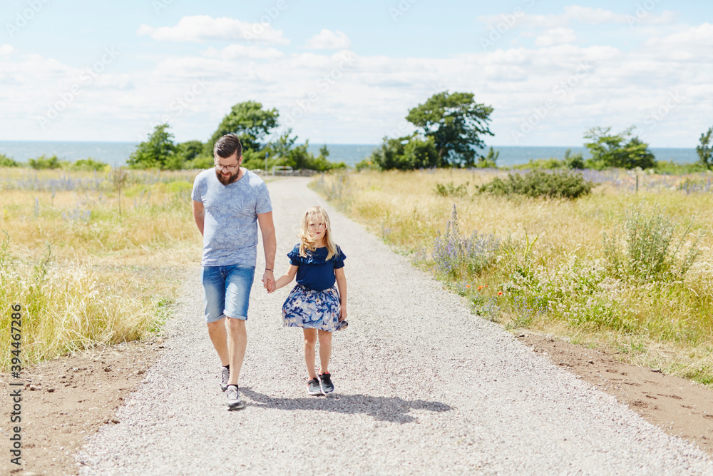 Father and daughter walking together, Sweden Father and daughter walking together, Sweden