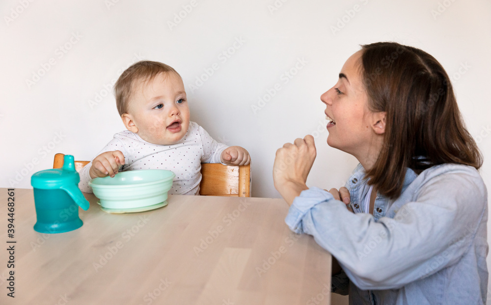 Mother with baby at table, Sweden Mother with baby at table, Sweden