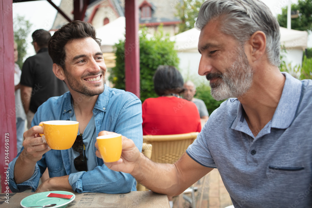 two men cheers drink coffee two men cheers drink coffee