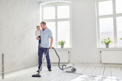 Wallpaper Mural Father carrying toddler while vacuum cleaning, Sweden Torontodigital.ca