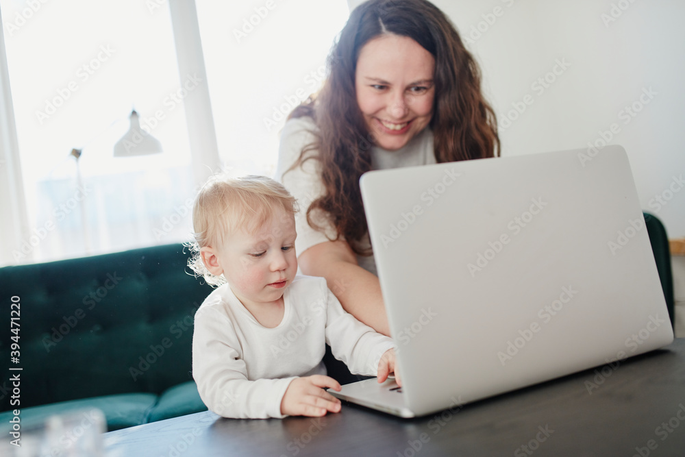 Mother and toddler son using laptop, Sweden Mother and toddler son using laptop, Sweden