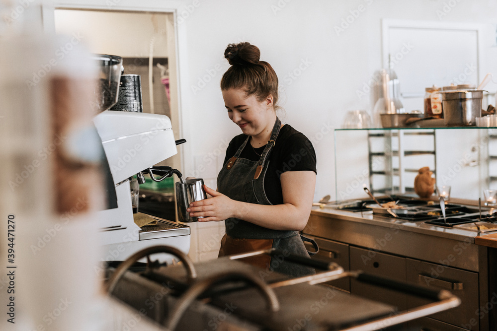 Smiling woman working in cafe, Sweden Smiling woman working in cafe, Sweden