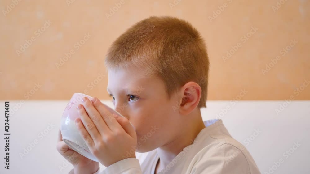 young child is drinking milk on the mug young child is drinking milk on the mug