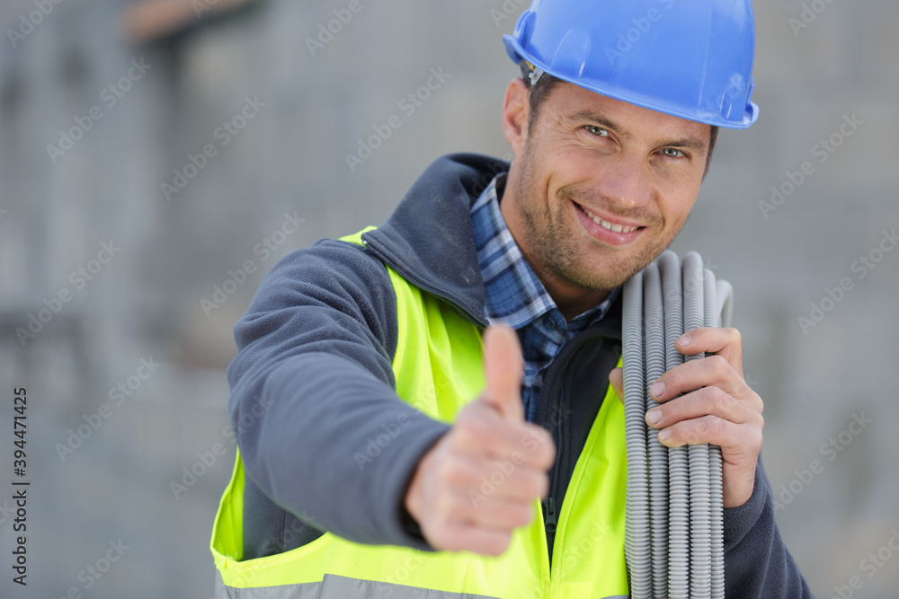 worker with water pipe showing thumb worker with water pipe showing thumb