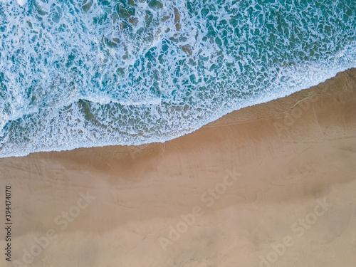 Beach shore green water waves top view aerial drone shot
