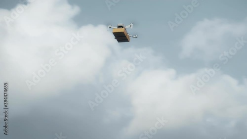 flying on a sky delivery drone with holding a .cardboard parcel photo