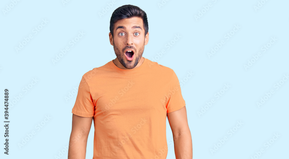 Young hispanic man wearing casual clothes scared and amazed with open mouth for surprise, disbelief face Young hispanic man wearing casual clothes scared and amazed with open mouth for surprise, disbelief face