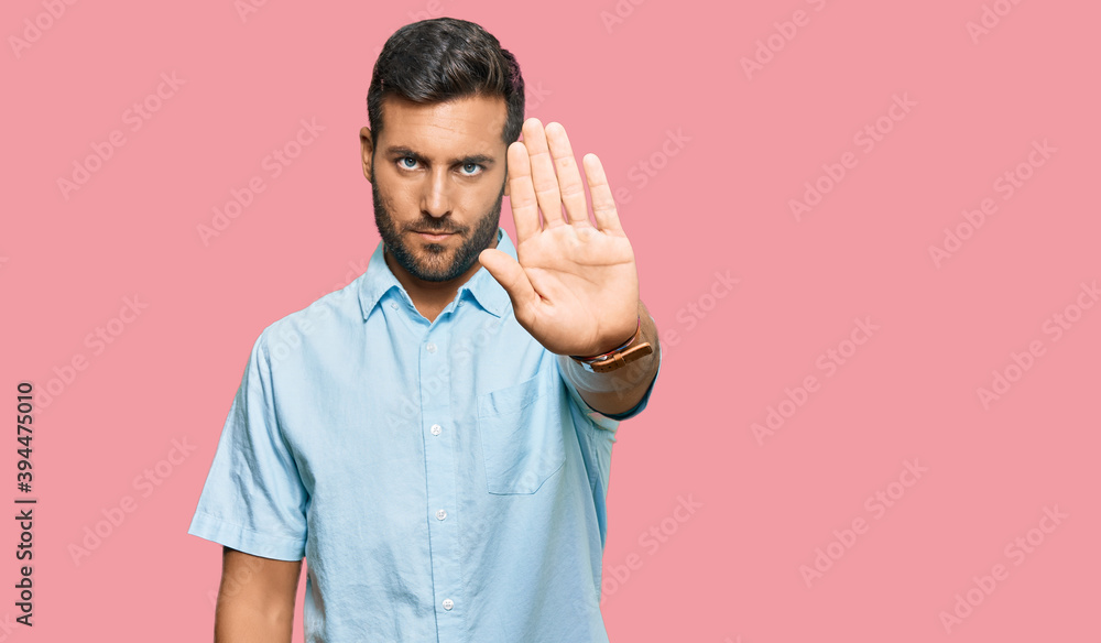 Handsome hispanic man wearing casual clothes doing stop sing with palm of the hand. warning expression with negative and serious gesture on the face. Handsome hispanic man wearing casual clothes doing stop sing with palm of the hand. warning expression with negative and serious gesture on the face.