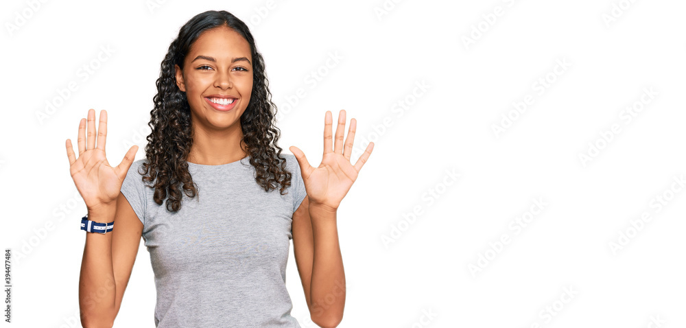 Young african american girl wearing casual clothes showing and pointing up with fingers number ten while smiling confident and happy. Young african american girl wearing casual clothes showing and pointing up with fingers number ten while smiling confident and happy.