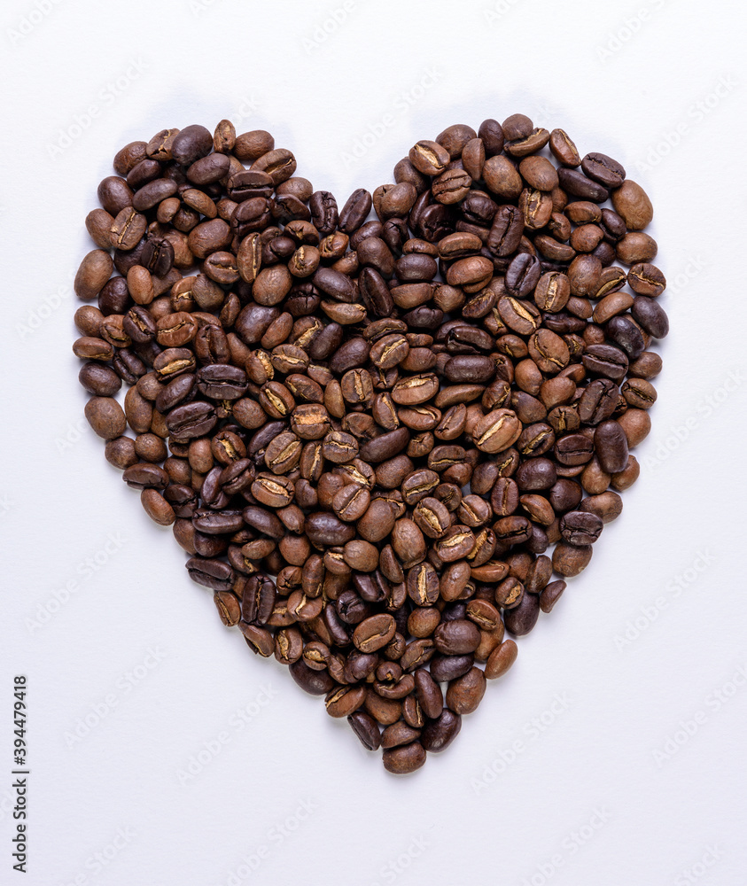 Heart shape made out of coffee beans on a white background Heart shape made out of coffee beans on a white background