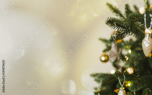 Beautiful Christmas tree with golden toys and garland lights. New Year and Christmas holidays.Closeup holiday and celebration  composition.Banner format