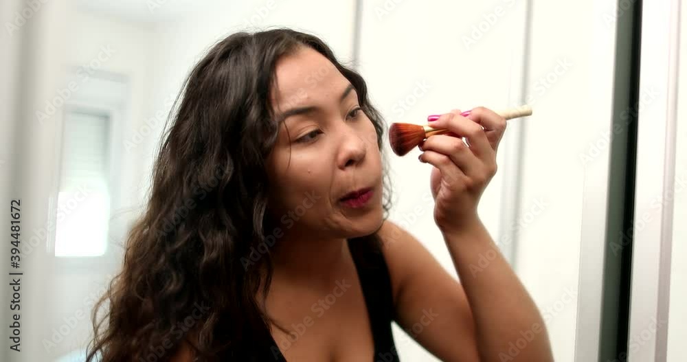 Latina hispanic girl applying make-up. Young woman preparing to go out in front of mirror reflection Latina hispanic girl applying make-up. Young woman preparing to go out in front of mirror reflection