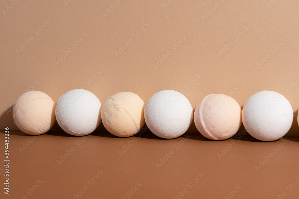 The homemade organic bath bombs on beige background. Spa concept. Presents for body. Space for text. The homemade organic bath bombs on beige background. Spa concept. Presents for body. Space for text.