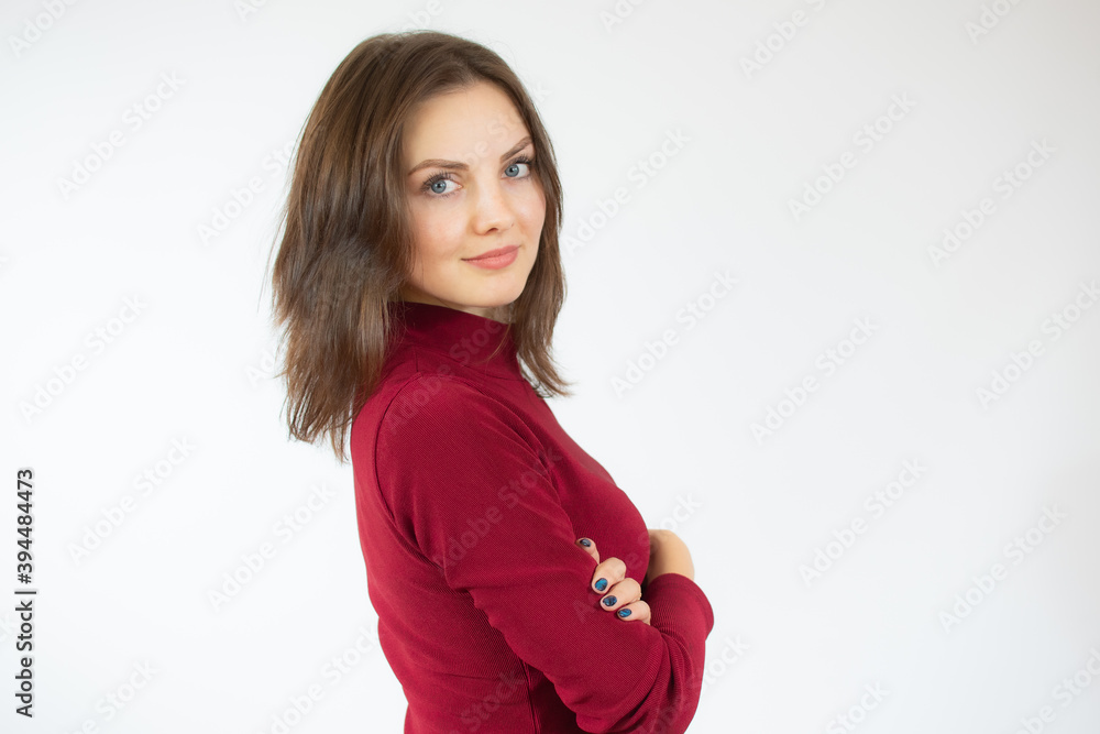Smiling young brunette woman in red sweater posing isolated on white background studio portrait. People sincere emotions lifestyle concept. Mock up copy space. Holding hands crossed Smiling young brunette woman in red sweater posing isolated on white background studio portrait. People sincere emotions lifestyle concept. Mock up copy space. Holding hands crossed